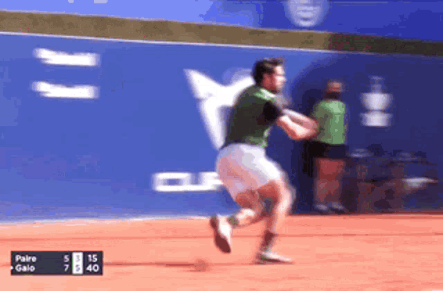 a man in a green shirt and white shorts is running on a tennis court in front of a scoreboard that says paire gaio