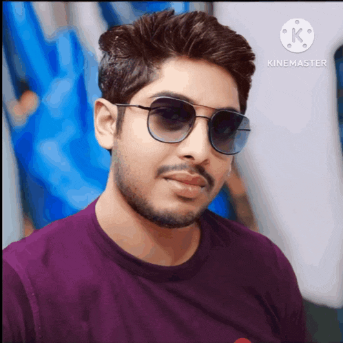 a man wearing sunglasses and a purple shirt is displayed in a video made by kinemaster