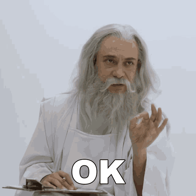 a man with a beard is holding a clipboard with the word ok written on it