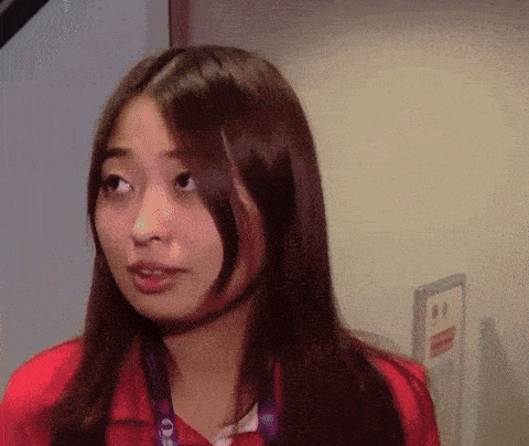 a woman in a red shirt has a lanyard around her neck that says ' one '