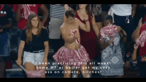 a man in a cheerleader outfit is standing in a crowd