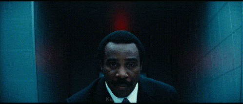 a dark hallway with a red exit light and the words mtnewsman below it