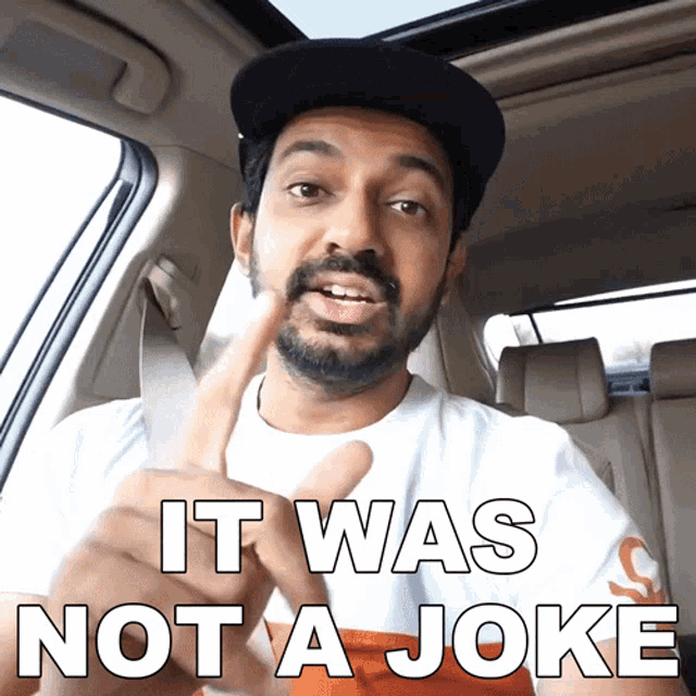 a man sitting in a car with the words it was not a joke above him