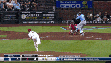 a baseball game is being played with an ad for geico in the outfield