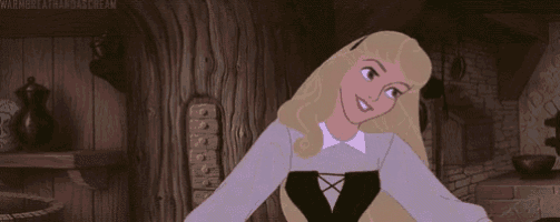 aurora from sleeping beauty is standing in a room with her hands in her pockets .