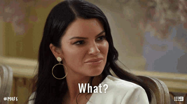 a woman sitting in a chair with a caption that says " what "