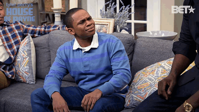a poster for tyler perry 's house of payne with a man sitting on a couch