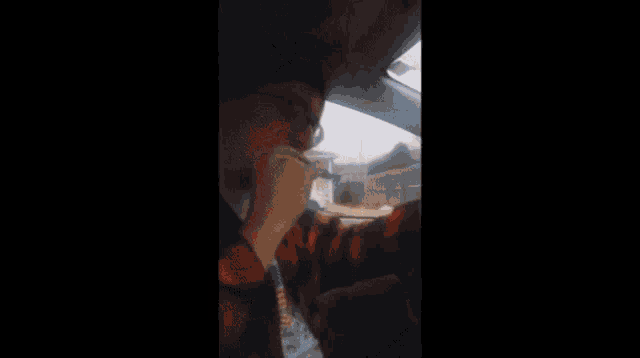a blurry picture of a man wearing glasses and a hat