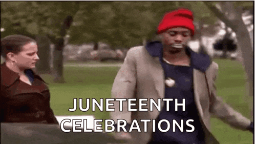 a man in a suit and red hat is dancing in a park .