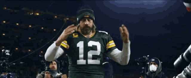 a green bay packers player with the number 12 on his shirt