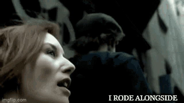 a woman with red hair is standing next to a man and the words i rode alongside are visible