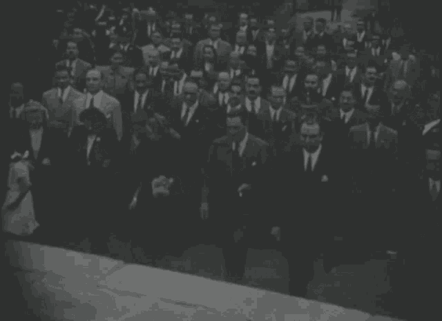 a black and white photo of a large crowd of people