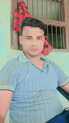 a man in a blue shirt with the letter b on it