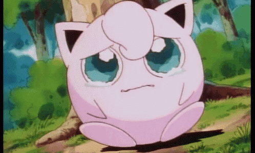 jigglypuff from pokemon is crying while sitting on the ground .