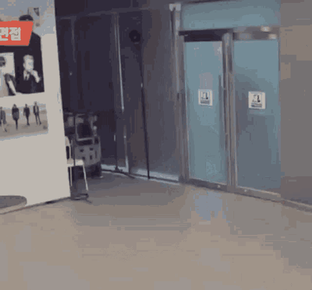 a room with a table , chairs , and a sign on the wall that says ' a ' on it .