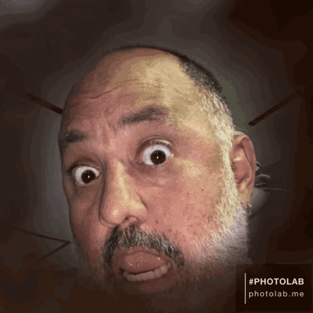 a man with a beard is making a funny face with a photolab.me watermark