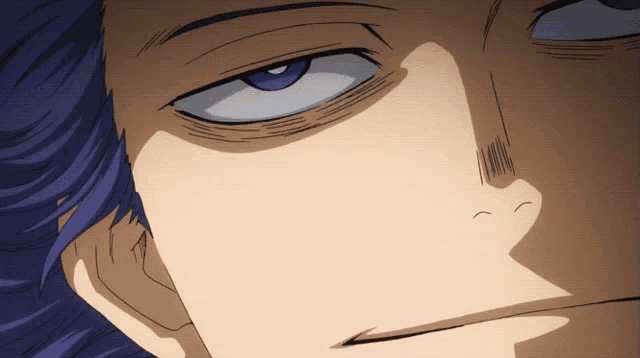 a close up of a person 's face with a purple eye