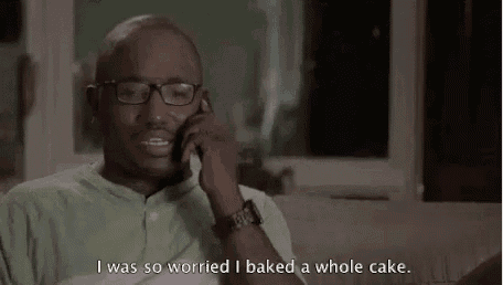 a man wearing glasses is talking on a cell phone .