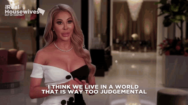 a woman in a black and white dress says i think we live in a world that is way too judgmental