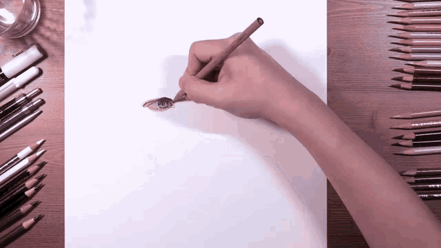 a person is drawing a picture of an eye with a pencil