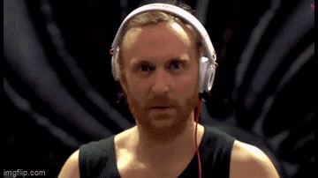 a man with a beard wearing headphones looks at the camera .
