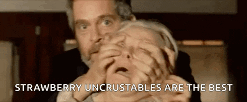 a man is holding a woman 's mouth with the words strawberry uncrustables are the best on the bottom .