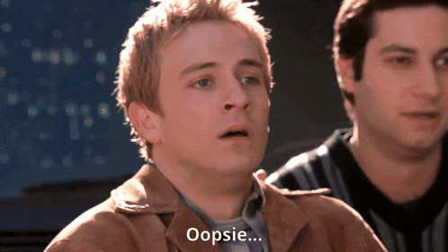 a man in a brown jacket says oopsie in front of two other men