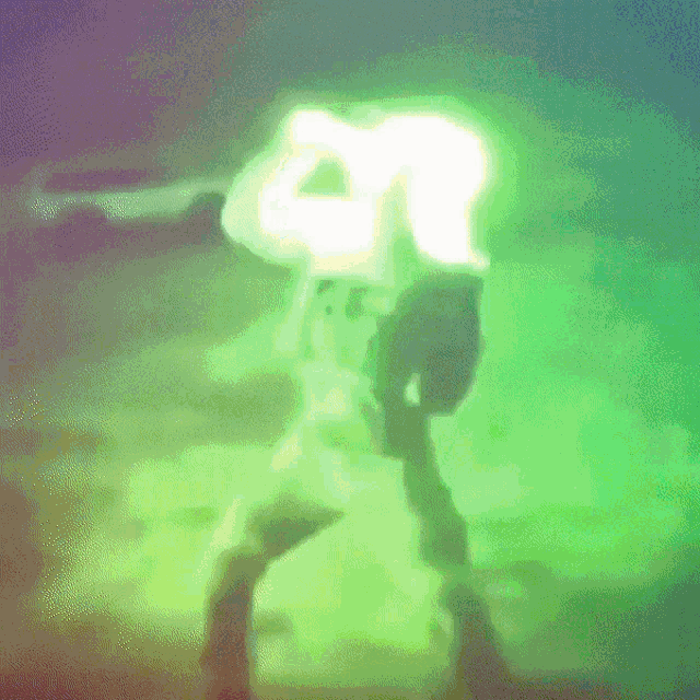 a silhouette of a person in a green light with the letter r on their head