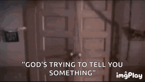 a person is standing in front of a door with the words `` god 's trying to tell you something ''