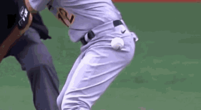 a baseball player is getting ready to throw a ball .