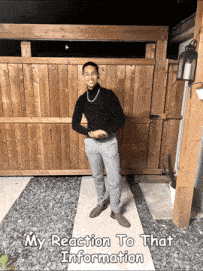 a man standing in front of a wooden fence with the words my reaction to that information below him
