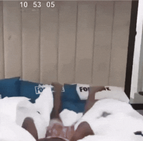 a person laying on a bed with a blue pillow that says " for " on it