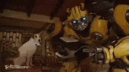 a close up of a yellow robot with blue eyes holding a banana .