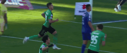 a soccer player in a green jersey with the number 2 on the back