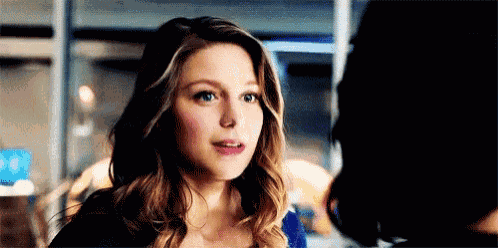 a close up of a woman 's face looking at another woman in a room .