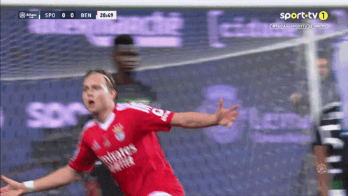 a soccer player wearing a red jersey that says emirates airlines on the sleeves