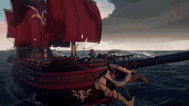 a pirate ship with a red sail is in the ocean