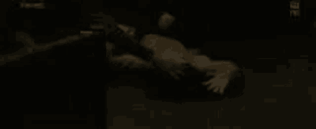 a person is laying on their back in a dark room