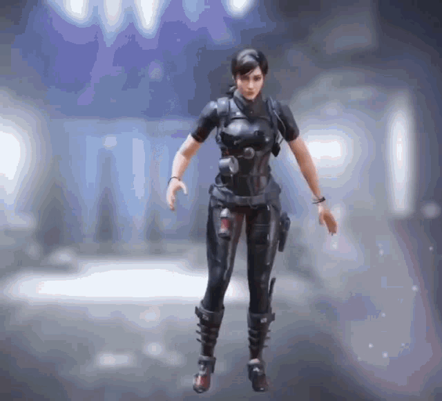 a woman in a black jumpsuit is standing in a dark room