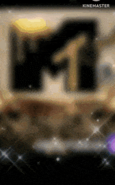 a blurred image of a mtv logo with sparkles in the background