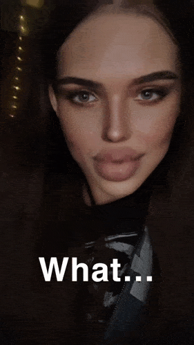 a close up of a woman 's face with her tongue out and the word what on the bottom