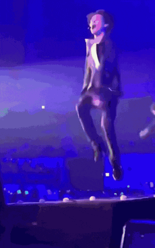 a blurry picture of a man jumping in the air
