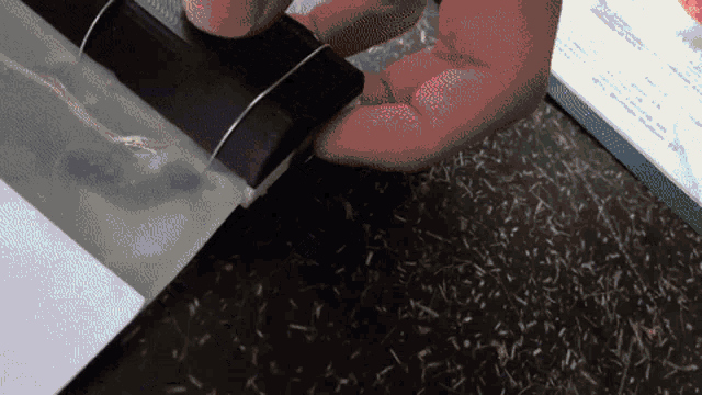 a close up of a person using a stapler