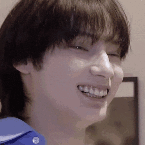 a close up of a person 's face with a smile on it .
