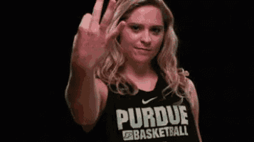 a woman in a purdue basketball jersey is making an ok sign with her hand .