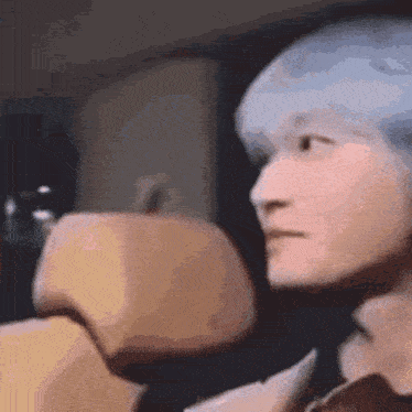 a close up of a person 's face while sitting in a car seat .