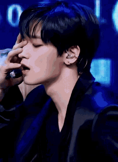 a close up of a person covering their nose with their hand