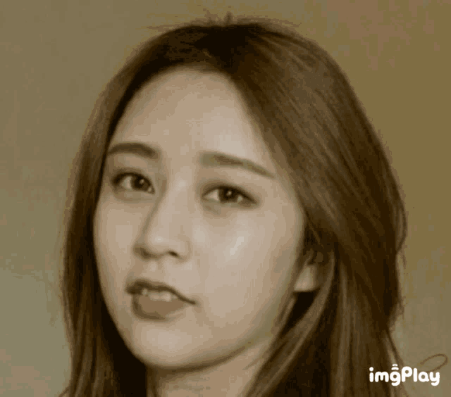 a close up of a woman 's face with the word imgplay visible
