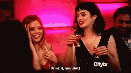 a woman says drink it you slut while holding a shot glass