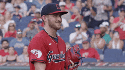 a baseball player wearing a red uniform that says guardia on it
